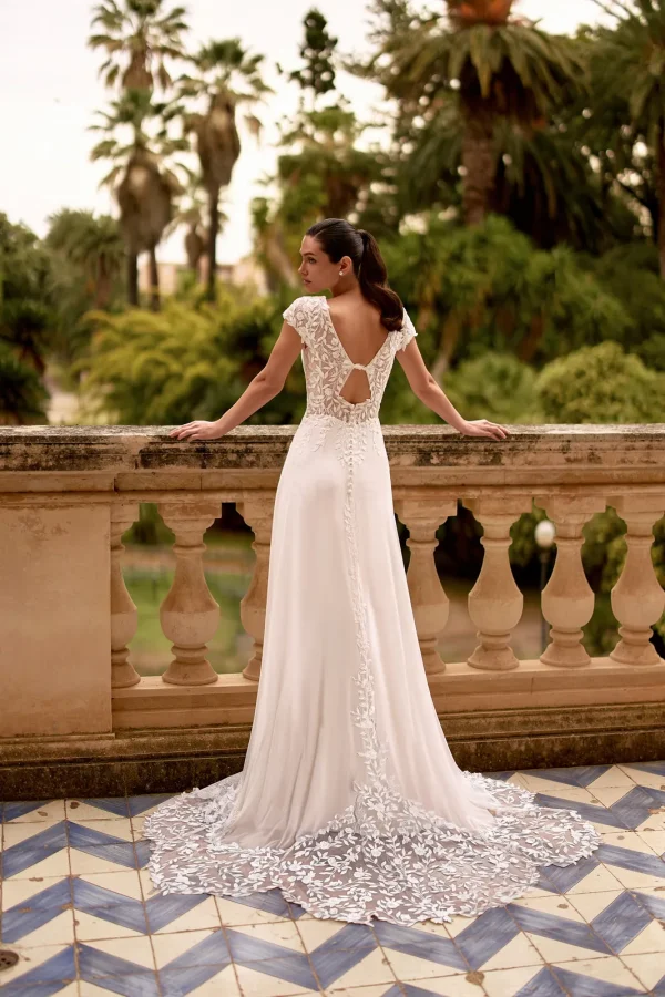 Dos ouvert et traîne en dentelle d'une robe de mariée droite en mousseline