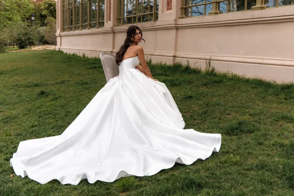 Dos boutonné et traîne volumineuse d'une robe de mariée princesse en mikado