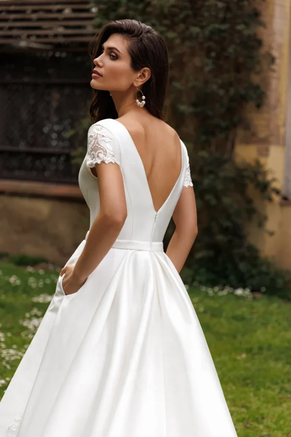 Dos en V profond et mancherons en dentelle d'une robe de mariée princesse