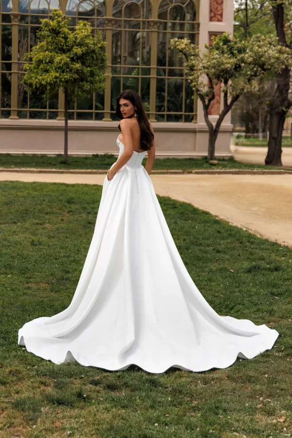 Dos boutonné et traîne d'une robe de mariée princesse bustier en satin