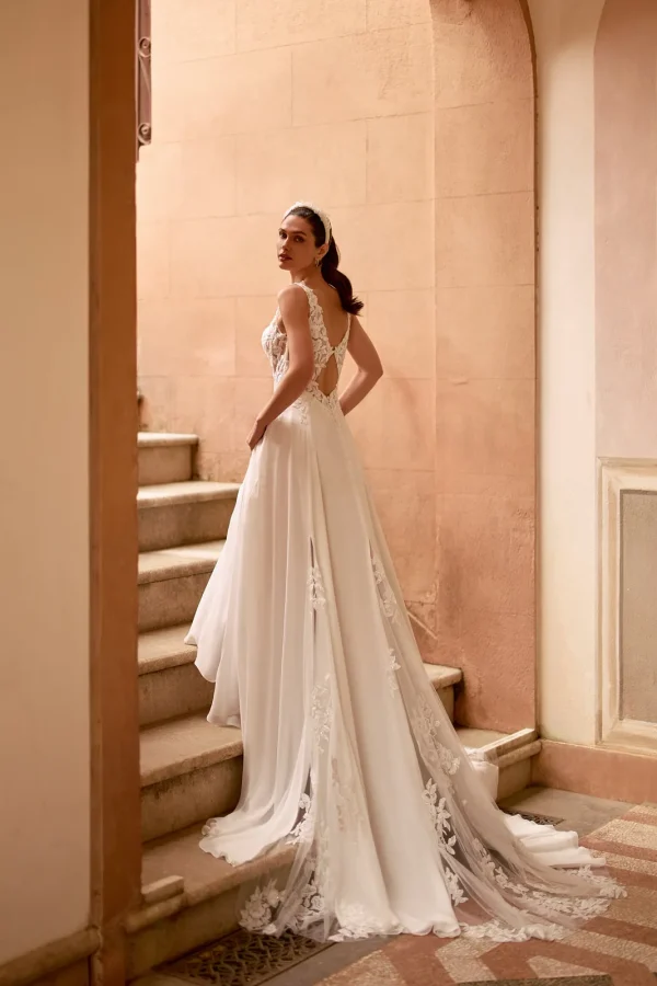 Dos ajouré et traîne en dentelle d'une robe de mariée trapèze en mousseline