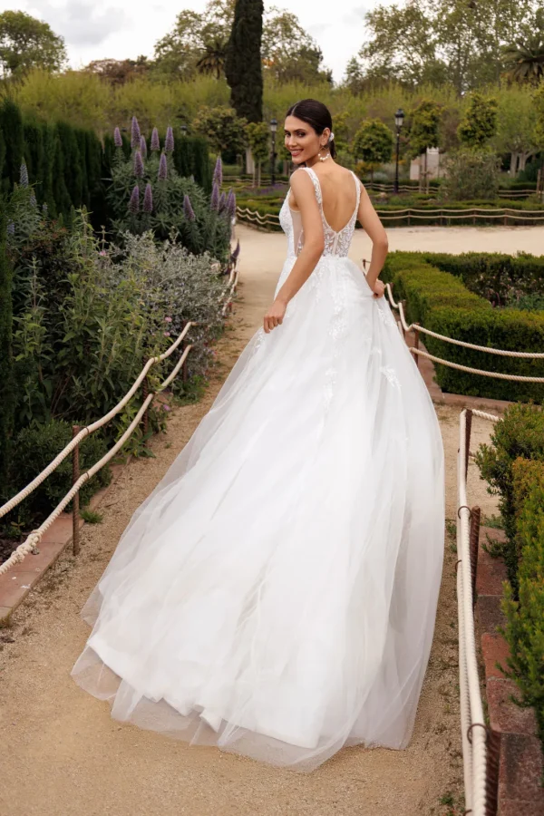 Dos nu d'une robe de mariée trapèze en tulle portée sans ses manches amovibles