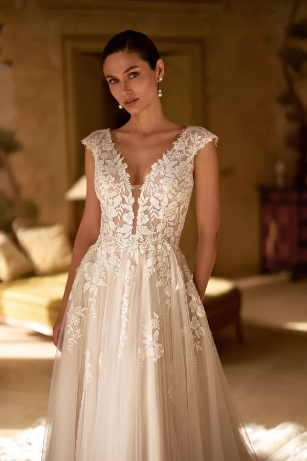 Décolleté en V plongeant et corsage en dentelle d'une robe de mariée trapèze nude